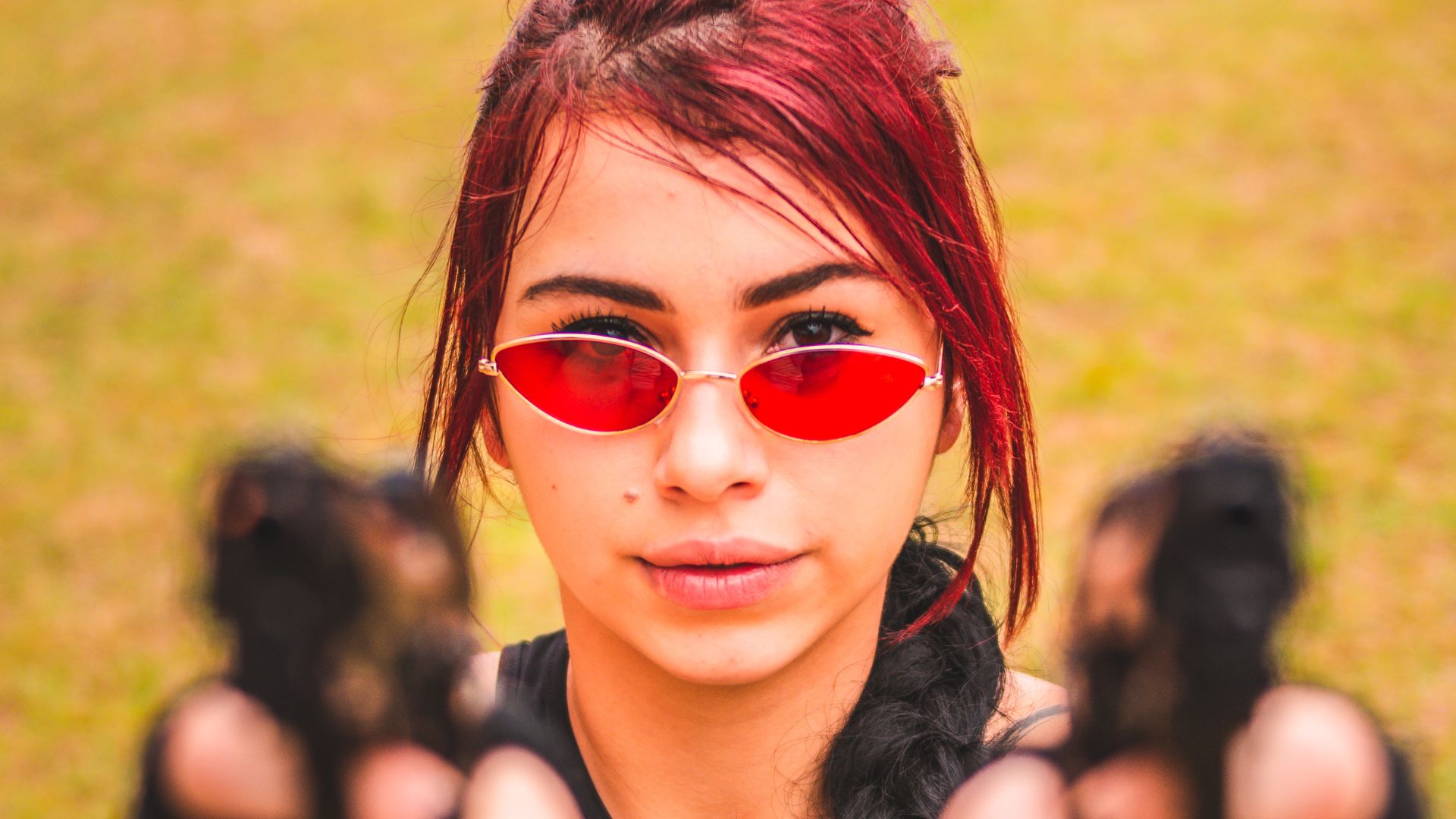 A Woman wearing Sunglasses holding Guns