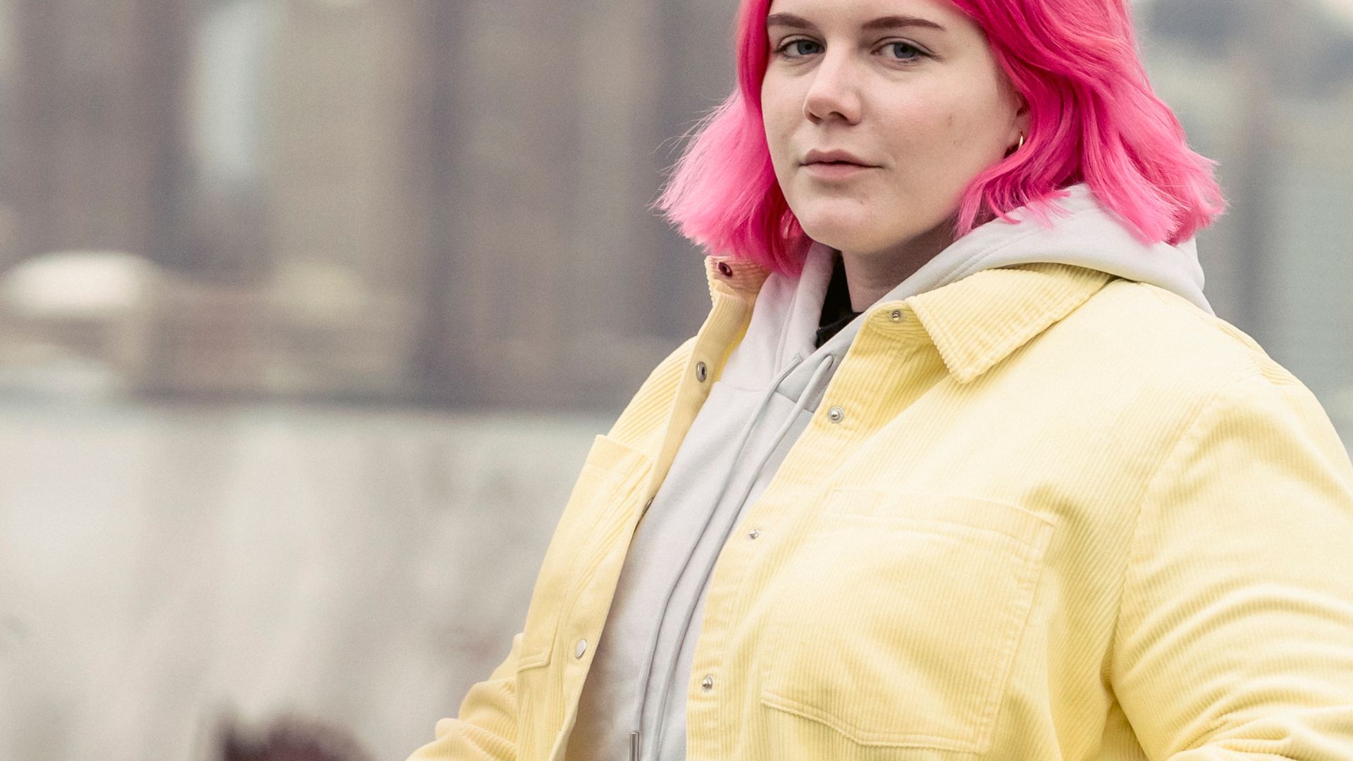 A Woman with Colored Hair Wearing a Yellow Jacket