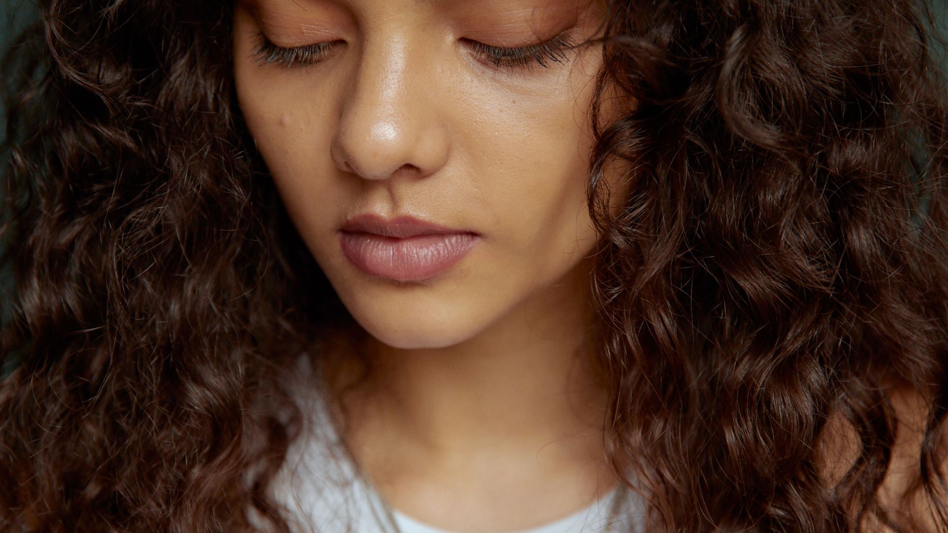 Close-Up Shot of a Pretty Curly-Haired Woman