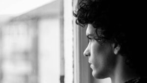 Man Standing in Front of Window