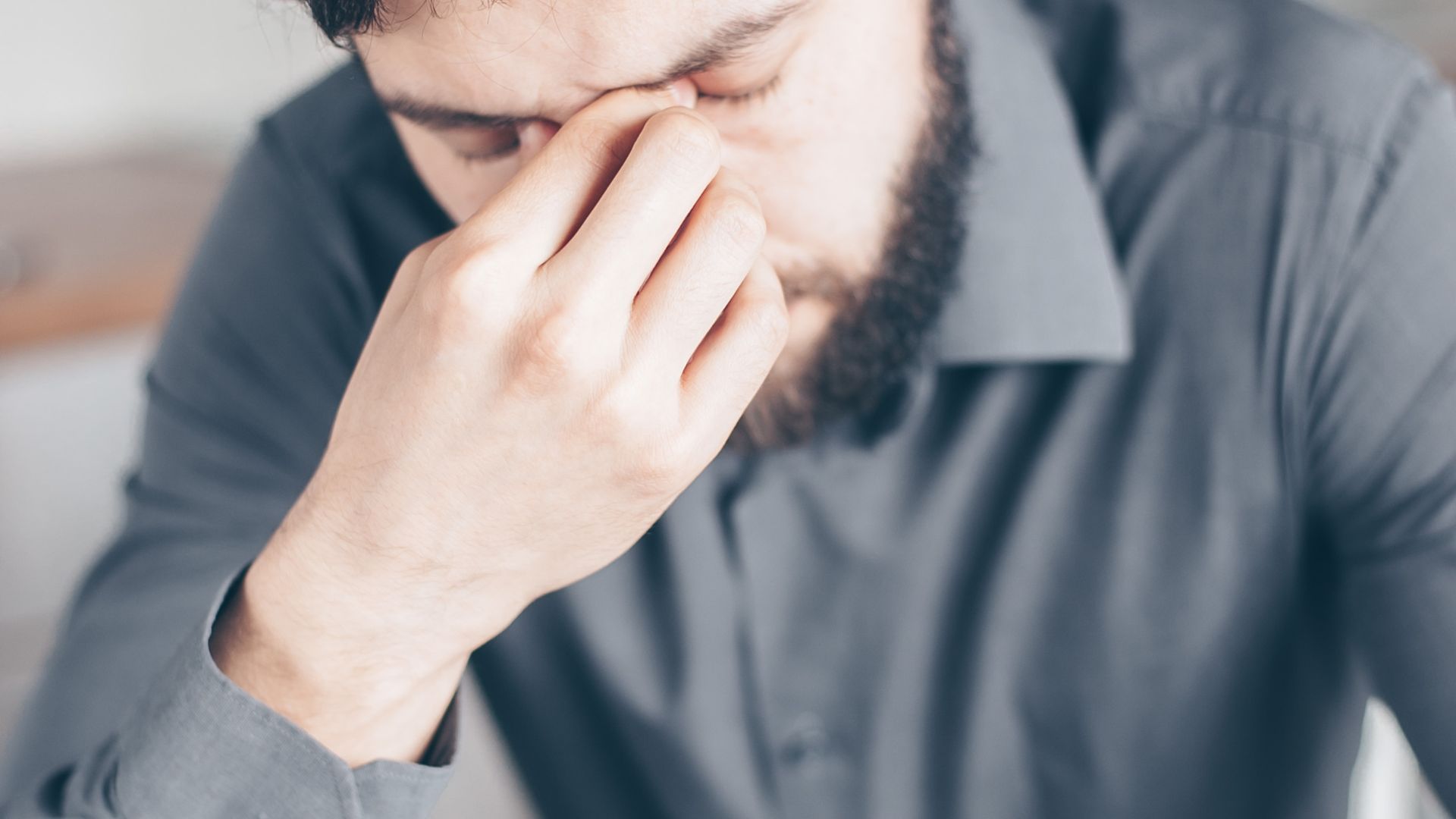 Man in Gray Dress Shirt Feeling Exhausted