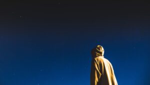 Person Standing Under Dark Sky