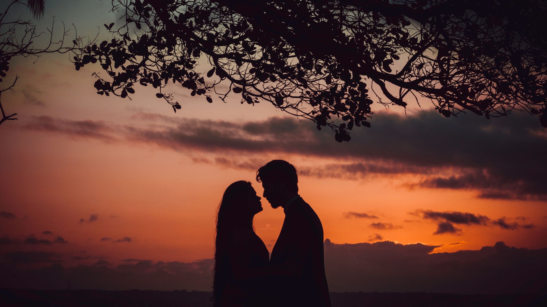 Photo of Couple Facing Each Other During Golden Hour