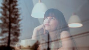 Photo of an Attractive Woman Thinking Inside a Coffee Shop