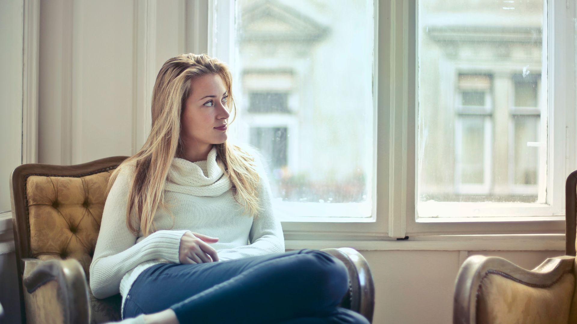 Photography of Woman Sitting on Chair Near Window