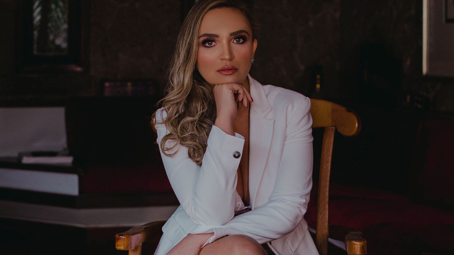 Portrait of Blonde Woman Sitting on Chair