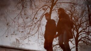 Reflection of Couple Holding Hands