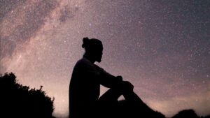 Silhouette of Man Standing Under Starry Night