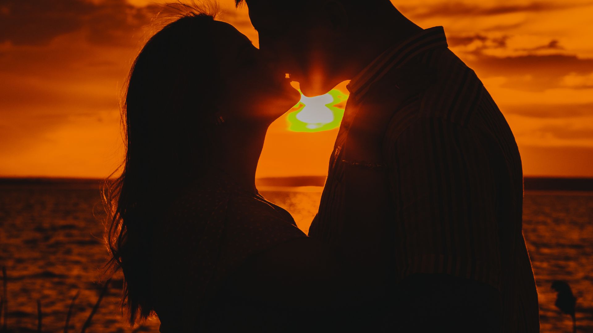 Silhouette of Man and Woman Kissing during Sunset