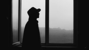 Silhouette of Person Standing Near Window,.