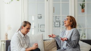 Two Women Talking in a Living Room