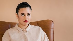 Woman Sitting on Brown Chair