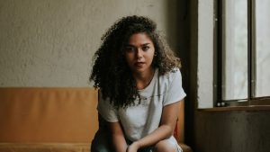 Woman Sitting on Chair Beside Window