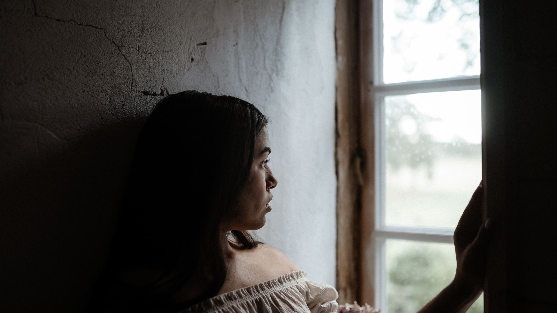 Woman Standing Beside Window ,.