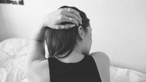 Woman in Black Tank Top Covering Her Face With Her Hair