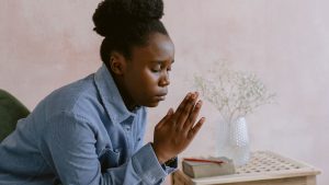 Young Woman Sitting and Praying